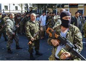 Pro-Russian gunmen guard parade dozens of captured Ukrainian soldiers during a march  in mockery of the country's Independence Day celebrations  in the main separatist stronghold Donetsk on August 24, 2014.
