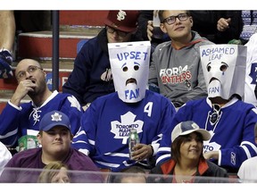 Toronto Maple Leafs fans wear bags over their heads in the third period of an NHL hockey game against the Florida Panthers, Thursday, April 10, 2014, in Sunrise, Fla. The Panthers defeated the Maple Leafs 4-2.