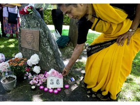 Jagada Venkateswaran places flowers on photographs of her niece and sister-in-law, both of whom were killed in the Air India Bombing, at a memorial ceremony in 2009 in Toronto.