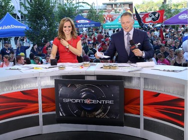 TSN's Kate Beirness (L) and Darren Dutchyshen (R) host a live TSN broadcast on the plaza during a family friendly event during the Ottawa Redblacks and Calgary Stampeders match at TD Place in Ottawa on August 24, 2014.