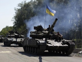 Ukrainian troops patrol near the eastern Ukrainian city of Debaltseve in the Donetsk region on August 3, 2014.