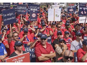 Union workers protest over a provincial proposal to overhaul pension plans at the legislature in Quebec City on Wednesday, August 20, 2014.