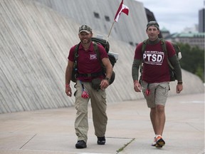 Veterans Steve Hartwig, left, and Jason McKenzie walk at the Canadian War Museum Friday Aug. 15, 2014 as part of a cross-Canada march to raise awareness for post-traumatic stress disorder.