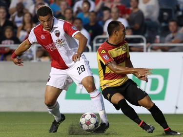 Vini Dantas #28 of the Ottawa Fury demes around Shawn Chin #17 of the Fort Lauderdale Strikers during an NASL match at TD Place in Ottawa on August 9, 2014.