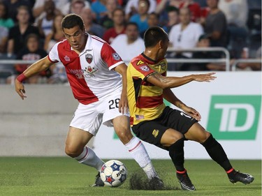 Vini Dantas #28 of the Ottawa Fury demes around Shawn Chin #17 of the Fort Lauderdale Strikers during an NASL match at TD Place in Ottawa on August 9, 2014.