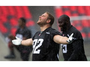 Zack Evans embraces the rain shower as the Ottawa Redblacks practice at TD Place on Wednesday morning.