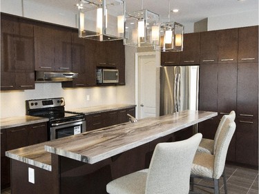 The Windsor has just a few upgrades, including a swirling, granite-style laminate countertop on the dual-level island. Kitchen cabinetry is a sleek, chocolate birch that stretches almost to the ceiling.