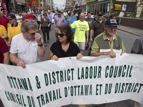 Members and supporters of the Ottawa & District Labour Council with their banner. Over a thousand people joined in the Labour Day parade in Ottawa Sept 1, sponsored by the Ottawa & District Labour Council. The parade started at City Hall and finished with a picnic at McNabb Park.