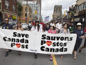 Postal workers protest  spending cuts in 2014. The Liberals say they will overrule the post office's decision to drop door-to-door delivery, even while they vow to take seriously the advice of public servants, including, presumably, those who manage Canada Post.