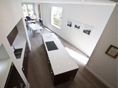 A partial two-storey opening in the kitchen creates the illusion of even more space than the already open concept projects. Set on an angle to the rest of the main living area, the jog in the design mimics a similar jog in the property.