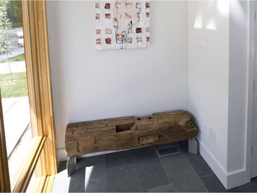 The foyer, accented with an old barn beam bench made by Jakub Ulak, starts off quite wide before compressing to about a third of its width as you move into the main living area. The idea is to funnel the view into the home, Ulak says.