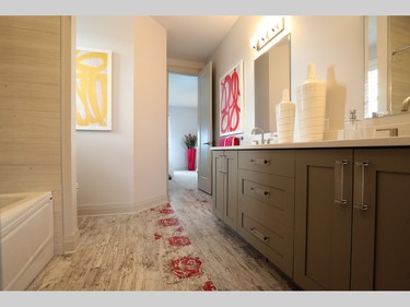 Up on the second floor, the tile in a Jack and Jill bathroom combines the rustic feel of a wood-grain look with playful embossed coral red roses for a fun girls’ space between two of the bedrooms, which are appropriately decorated for daughters.