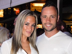 ALTERNATIVE CROP
A picture taken on January 26, 2013 shows Olympian sprinter Oscar Pistorius posing next to his girlfriend  Reeva Steenkamp at Melrose Arch in Johannesburg. South Africa's Olympic sprinter Oscar "Blade Runner" Pistorius was taken into police custody on February 14, 2013, after allegedly shooting dead his model girlfriend having mistaken her for an intruder at his upscale home. AFP PHOTO / WALDO SWIEGERSWALDO SWIEGERS/AFP/Getty Images