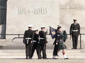 Members of the Royal Canadian Navy stand as a honour guard at the tomb of the Unknown Soldier at the War Memorial. There have been full-time guards at the memorial since vandals desecrated it in 2007.
