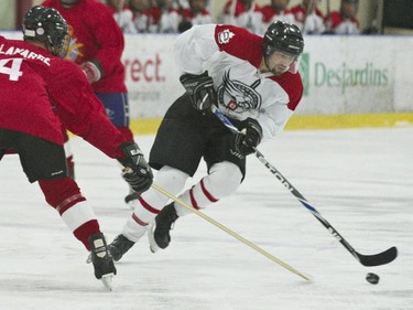 ECD Commando #44 Ben Stevenson keeps possession of the puck.