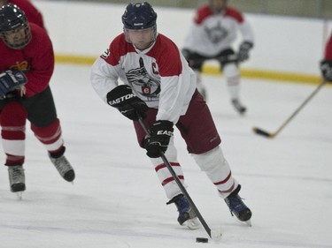 EDC Commando #91 Tony Young takes the puck through centre ice.