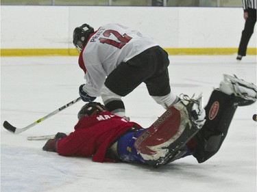 Goalie BGen Rob Mazzolin kept the puck away from EDC Commando #12 David Pratt.