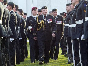 Governor General David Johnston, centre, inspects soldiers during a Sunset ceremony celebrating the 100th anniversary of the Patricia's Canadian Light Infantry and the Royal 22nd Regiment on Parliament Hill.