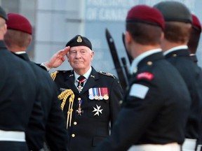 Governor General David Johnston salutes as members of the Princess Patricia's Canadian Light Infantry and the Royal 22nd Regiment march past on Parliament Hill.