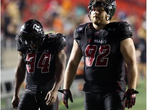 Swayze Waters, left and Zack Evans of the Ottawa Redblacks walk back dejected after the team's 7-5 loss to the BC Lions at TD Place in Ottawa, Sept. 5, 2014.