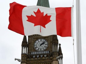 A Canadian flag blows in front of the Peace Tower on Parliament Hill in Ottawa, Ont., Wednesday, Oct. 24, 2012.