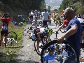 A Canadian rider is seen through the spare wheel, after she crashed with other riders during the women's road race in Ponferrada, Spain, on Saturday Sept. 27, 2014.