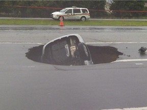 Juan Pedro Unger's Hyundai rests nose first in the sinkhole on Highway 174 in 2012.