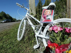 A ghost bike has been placed on River Road just outside of Manotick -  at the site of the accident that killed Laurie Strano during Saturday's Ride the Rideau.  (Julie Oliver / Ottawa Citizen)