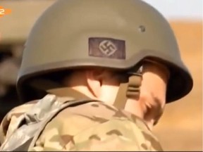 A news broadcast by German ZDF station on Sept. 8 showed soldiers of the Ukraine Azov Battalion in Mariupol with Nazi symbols on their helmets.