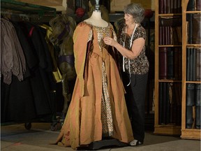 A selection of NAC English Theatre costumes, including this gown being adjusted by Diane McIntyre, are being sold off as fundraiser in October.