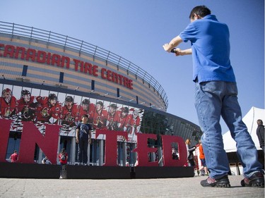 A young boy gets his picture taken as the "I" in United at the Ottawa Senators Fan Fest at Canadian Tire Centre, Saturday, Sept. 27, 2014.