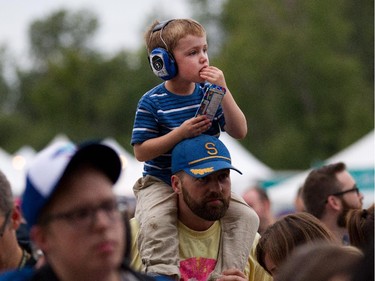 A youngster has his ears protected as the annual Ottawa Folk Festival kicks off Wednesday evening at Hog's Back Park.