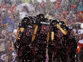 The Ottawa Redblacks huddle in the rain against the BC Lions during second half action at TD Place in Ottawa, September 5, 2014.