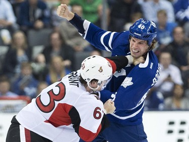 Toronto Maple Leafs forward Troy Bodie, right, fights Ottawa Senators defenceman Alex Grant (63) during second period pre-season NHL hockey action in Toronto on Wednesday, September 24, 2014.