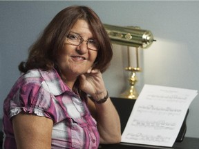 Allison Woyiwada poses by her piano inside her Ottawa home Sept. 9, 2014. After surgery to remove a massive brain aneurysm, music helped her recover.