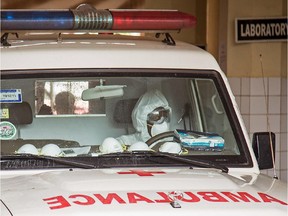 An ambulance drops people suspected of having been infected by the Ebola virus inside the Connaught Hospital, during a three-day lockdown to prevent the spread on the virus in Freetown, Sierra Leone, Sunday, Sept. 21, 2014.