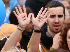 A visitor with a Star of David and the words 'Against Hatred Toward Jews' written on her hands attends a rally against anti-Semitism on September 14, 2014 in Berlin, Germany.