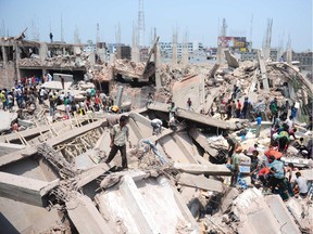 In this photograph taken on April 24, 2013, Bangladeshi civilian volunteers assist in rescue operations after an eight-storey building collapsed in Savar, on the outskirts of Dhaka.