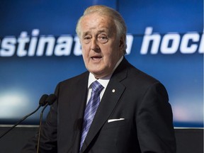 Quebecor Inc. chairman of the board Brian Mulroney, standing next to the Stanley Cup, greets participants during the launch of the NHL season on TVA Sports network Wednesday, September 3, 2014 in Boucherville, Que.