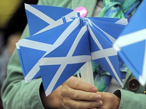 A pro-independence supporter holds campaign material.