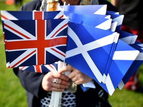 A  'no' vote supporter hold Union and Scottish flags.