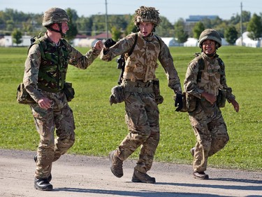 British soldiers share a fist bump as they run up to the firing line as the annual Canadian Armed Forces Small Arms Concentration (CAFSAC) was held at the Connaught Ranges and Primary Training Centre near Shirley's Bay.