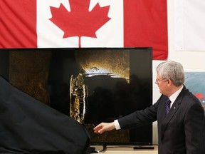 Prime Minister Stephen Harper unveils  an image of one of the ships belonging to the ill-fated Franklin Expedition.