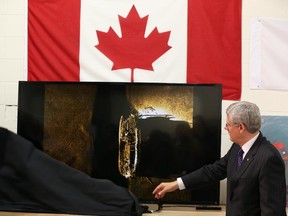 Canada's Prime Minister, Stephen Harper unveils an image of one of the ships belonging to the ill-fated Franklin Expedition which was lost in 1846, September 9, 2014.