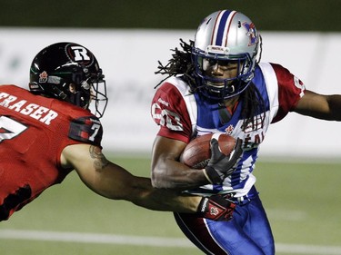 Ottawa Redblacks Eric Fraser (7) attempts to stop Montreal Alouettes James Rogers (80) during CFL football action between the Ottawa Redblacks and the Montreal Alouettes in Ottawa, Friday September 26, 2014.