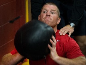 Chris Neil grimaces while throwing the medicine ball as the Ottawa Senators are given medicals and tested for strength and conditioning.