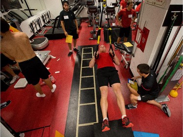 Chris Neil lifts does a horizontal pull-up as the Ottawa Senators are given medicals and tested for strength and conditioning.