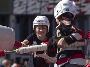 Cooper McAllister jousts with Isaac McAllister at the Ottawa Senators Fan Fest at Canadian Tire Centre, Saturday, Sept. 27, 2014.
