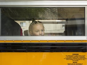 Dains Johnston takes the front seat of Bus No. 26, which will whisk her to her first day of senior kindergarten at Robert E. Wilson School.