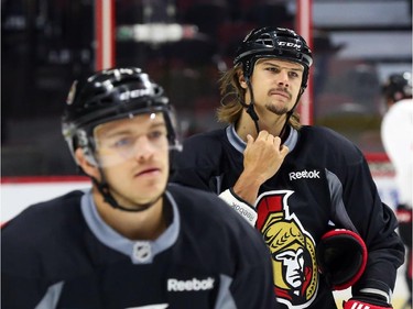Erik Karlsson, right, of the Ottawa Senators practices during morning skate at the Canadian Tire Centre.